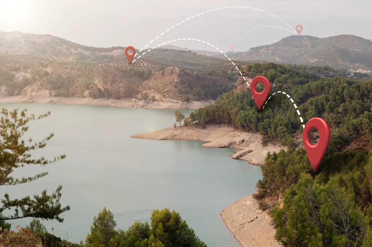 Mountain lake with travel route location pins on a map