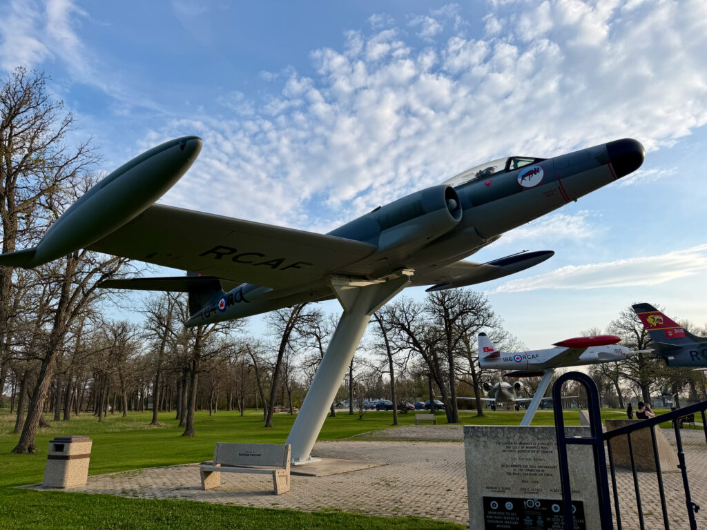 Air Force Heritage Air Park, Winnipeg: Planes, History and Coffee 27 Royal Canadian Air Force Avro Arrow jet fighter displayed as a monument in a park, with bare trees and blue sky in the background