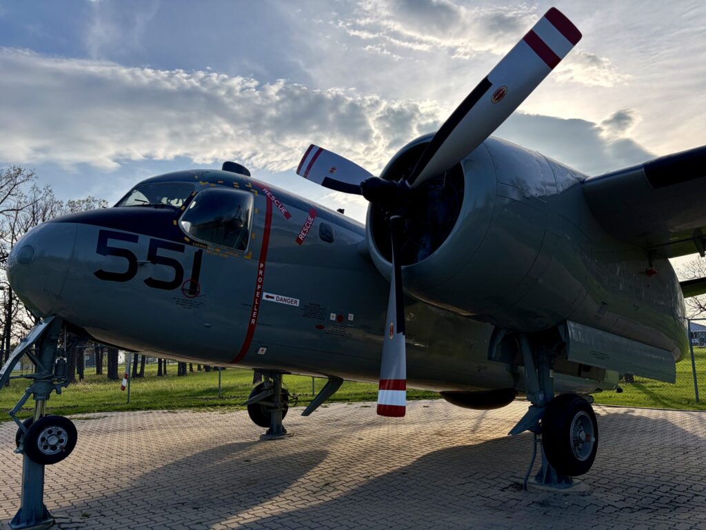 Air Force Heritage Air Park, Winnipeg: Planes, History and Coffee 51 Vintage military transport aircraft numbered 551 on display, featuring twin propellers, red and white striped fuselage markings, and landing gear, photographed outdoors against a cloudy sky