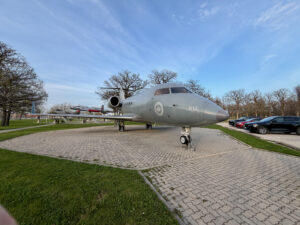 Air Force Heritage Air Park, Winnipeg: Planes, History and Coffee 35 Canadian Armed Forces Canadair CX-144 Challenger maritime patrol aircraft on static display, marked with tail number 612, parked on a brick plaza with bare trees and vehicles in the background