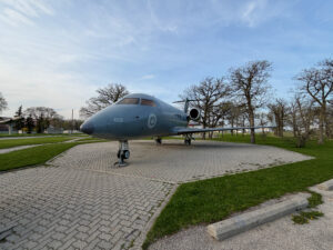 Air Force Heritage Air Park, Winnipeg: Planes, History and Coffee 36 Canadian Armed Forces CX-144 Challenger jet aircraft on display, marked with number 612 and maple leaf insignia, positioned on a brick plaza surrounded by grass and bare trees