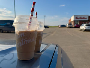 Air Force Heritage Air Park, Winnipeg: Planes, History and Coffee 5 Tim Hortons iced coffee drinks with red and white striped straws on a car hood in a parking lot