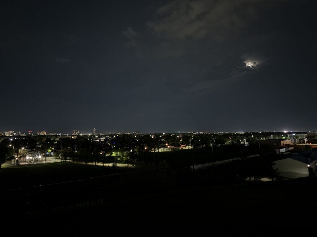 Westview Off-Leash Dog Park: Winnipeg's "Garbage Hill" and the First Park We Ever Walked in Canada 3 Night view of a city skyline with a full moon partially obscured by clouds