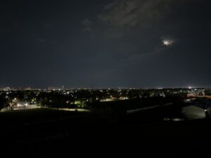Westview Off-Leash Dog Park: Winnipeg's "Garbage Hill" and the First Park We Ever Walked in Canada 13 Night view of a city skyline with a full moon partially obscured by clouds